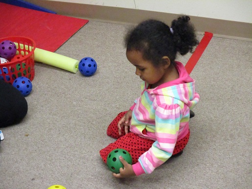 A child is playing with toys that make sound